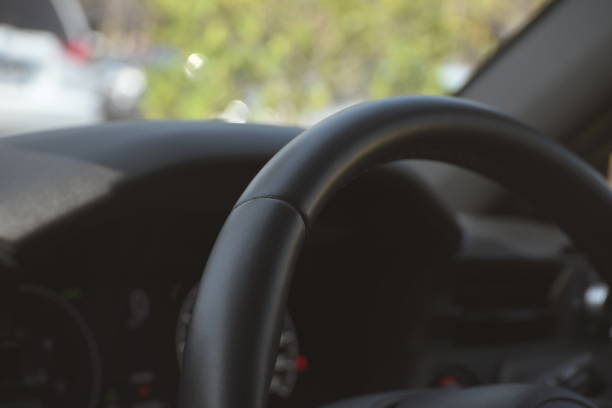 interior view of car with black leather, steering wheel with button