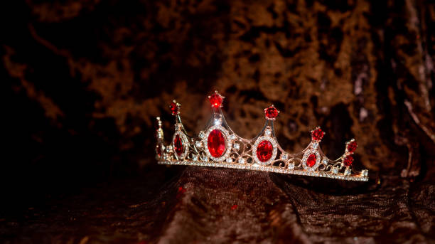 istock Royal Diadem, crown with ruby, red gemstones on velvet background 2176559350