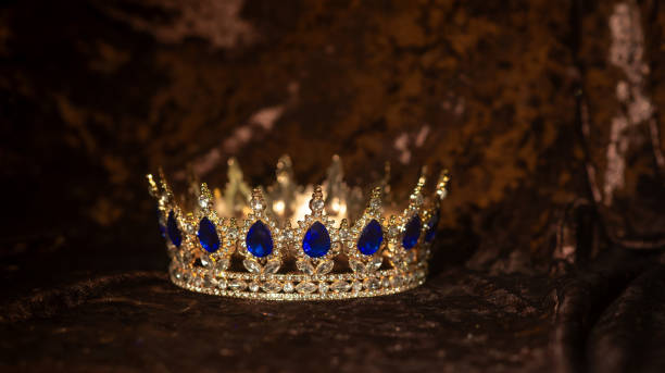 istock Royal crown blue gems, sapphires on velvet background 2176559353