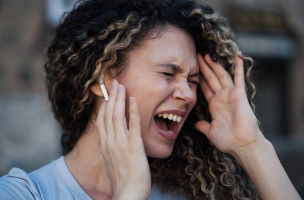 istock Young woman suffering from hearing loss 2176562171