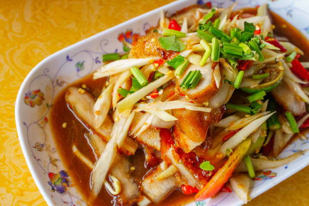 Closeup Thai food papaya salad with grilled pork neck on whitebackground isolation clippingpath.Isan Thai food is popular in Asia.