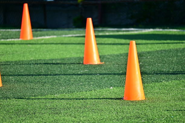 istock artificial green grass soccer field with orange training cones 2176563359