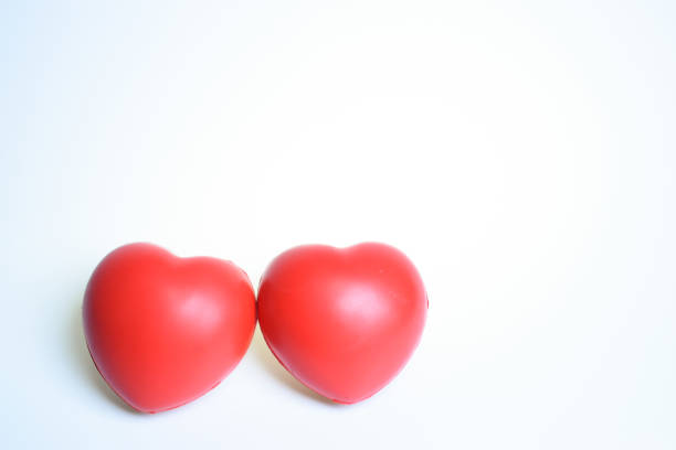 two red stress ball isolated on white background, heart shape toy