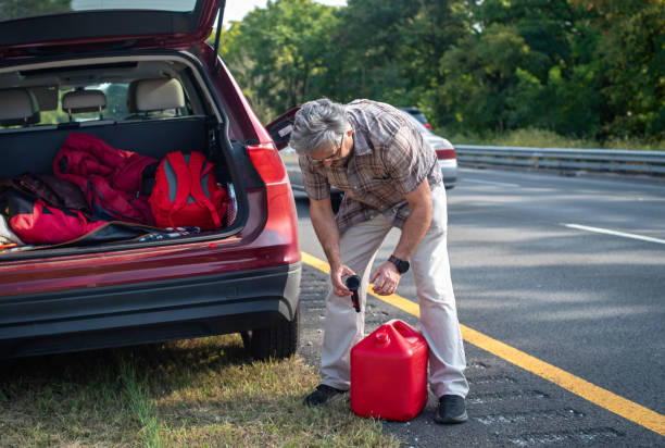 istock Refueling stranded vehicle. 53-year-old man pours gasoline into car on highway shoulder. 2176565704