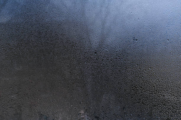 istock wet glass background. water drops on the window 2176579898