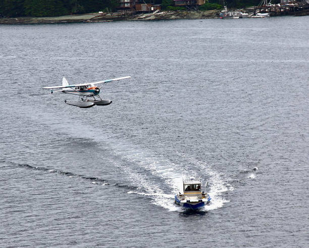 A close encounter between a landing seaplane and a small boat common to Alaska