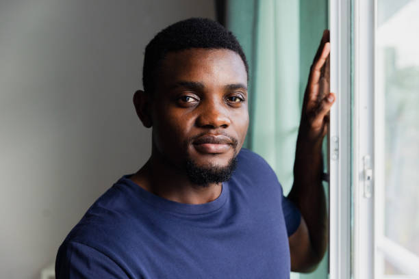 istock A Young Man Poses Confidently by a Window in a Bright Indoor Setting, Showcasing a Moment of Serenity and Thoughtfulness 2176582704