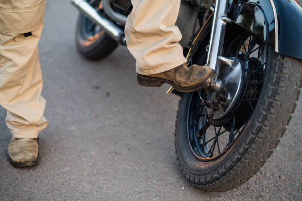 istock a biker near a motorcycle. biker boots 2176583468