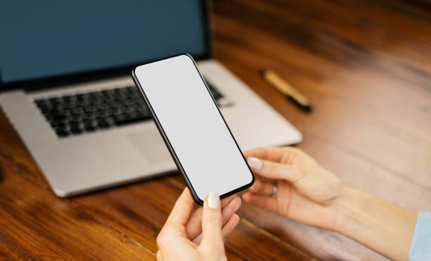 istock Mockup image of a woman using smartphone with blank screen on wooden table 2176585015