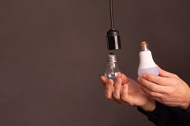 incandescent lamp and LED lamp in hand