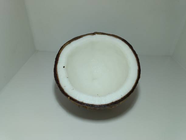 Half of coconut on white background. top view