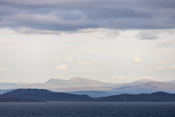 This image shows an ethereal abstract texture landscape background of remote rugged coastal mountains of northern Scotland in early morning light.