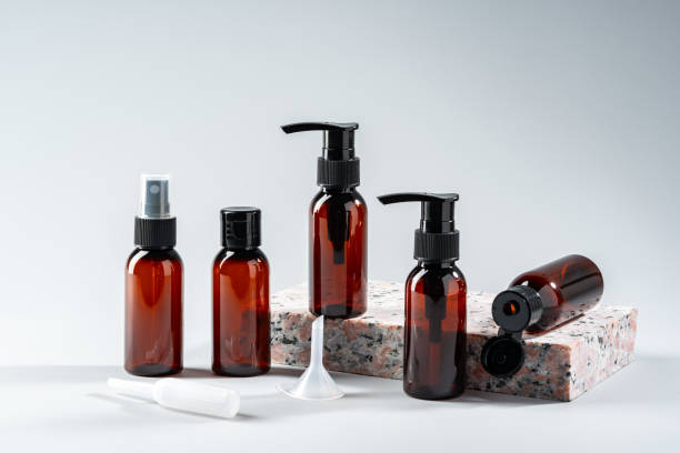 istock Elegant amber glass bottles displayed on a textured stone surface in a minimalist studio setting 2176593731