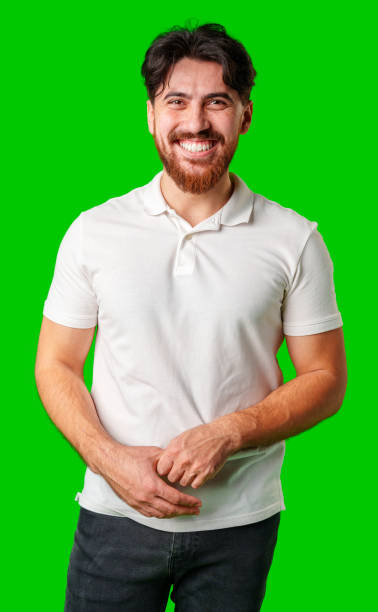 istock A smiling young man with a beard poses against a bright green background 2176595766