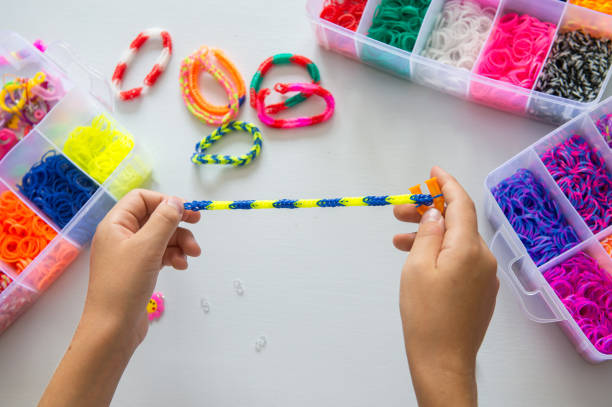 istock Child making colorful rubber band bracelet with a loom tool 2176597607