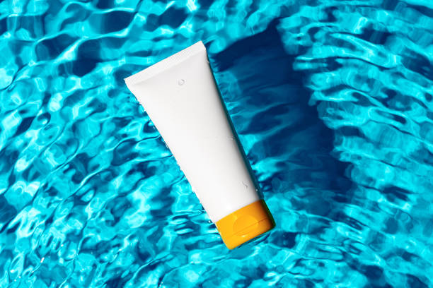istock Sunscreen bottle floating in a clear blue swimming pool on a sunny day 2176597974