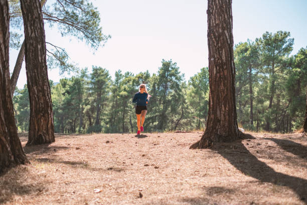 istock Young Woman Jogging in Forest 2176599714
