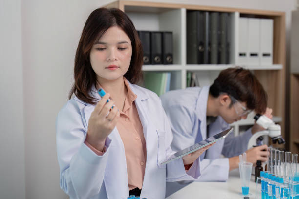 istock Female Scientist Conducting Chemical Analysis with Specimen and Digital Records 2176600566