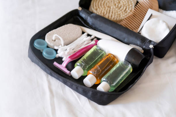 istock Travel cosmetics kit with bottles, brushes and cosmetics on bed 2176602018