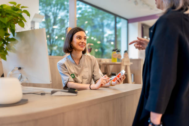 istock Saleswoman talking to a client in a pharmacy counter 2176603022