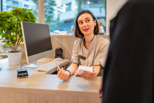 istock Pharmacist attending and talking with a client in the counter 2176603028