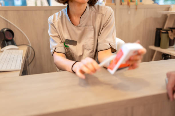istock Pharmacist holding a package of medicine attending a client 2176603036