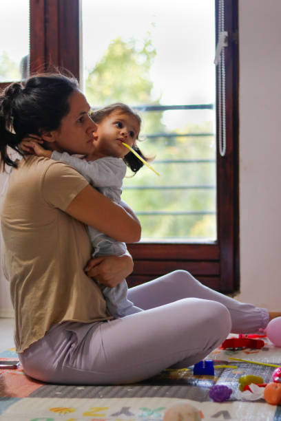 istock Mother hugs daughter while watching cartoons 2176603843
