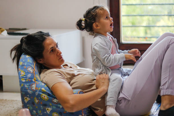 istock mother and girl watching tv 2176603933