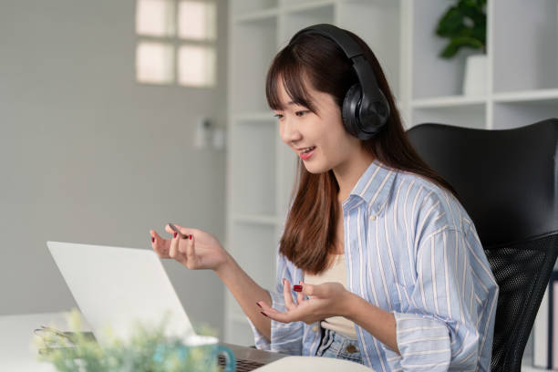 istock Young Woman Actively Listening and Interacting in Online Lecture 2176604298