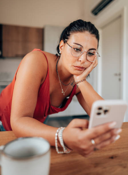 istock coffee break at home in the kitchen reading the smartphone 2176605710