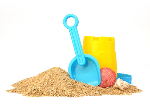 istock Plastic beach toys on pile of sand isolated on white background, Side view 2176605751