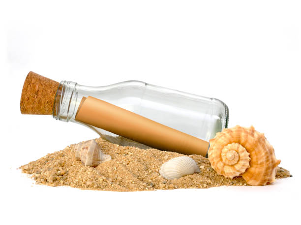 istock Bottle with a message on pile of sand isolated on white background, Side view 2176605777