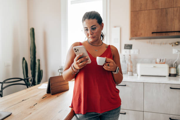 istock coffee break at home in the kitchen reading the smartphone 2176605854