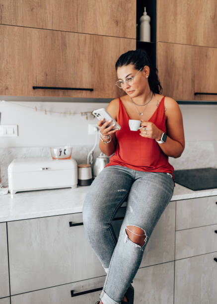 istock coffee break at home in the kitchen reading the smartphone 2176606022