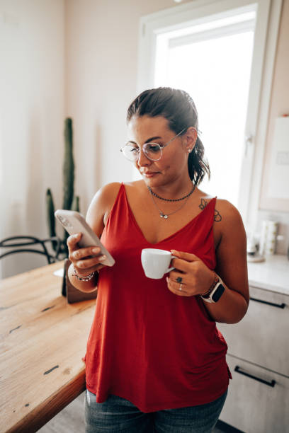 istock coffee break at home in the kitchen reading the smartphone 2176606093