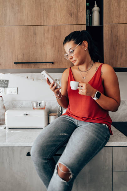 istock coffee break at home in the kitchen reading the smartphone 2176606216