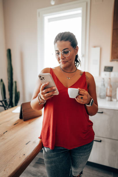 istock coffee break at home in the kitchen reading the smartphone 2176606247