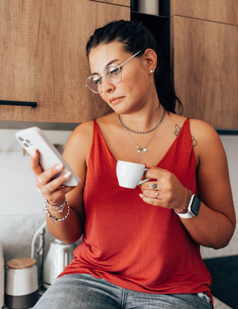 istock coffee break at home in the kitchen reading the smartphone 2176606341