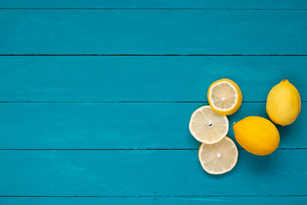 Fresh lemons on blue wooden background