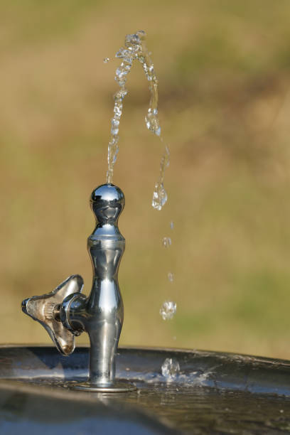 Athlete girl drinking water on a running track