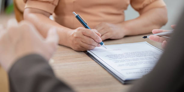 istock Real Estate Agent Assisting Client with Property Contract Signing 2176609803