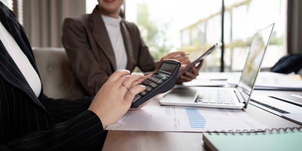 istock Financial Analyst Using Calculator for Data Review in Strategy Meeting. Concept of Collaborative Business Planning 2176611615