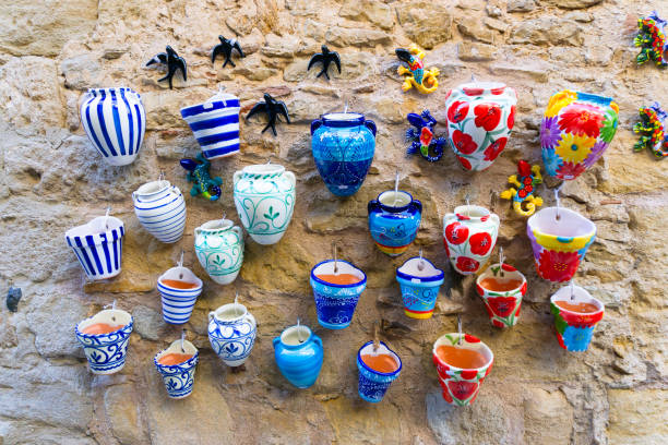 istock Different hand-designed and hand-painted pots displayed on an ancient stone wall 2176614033