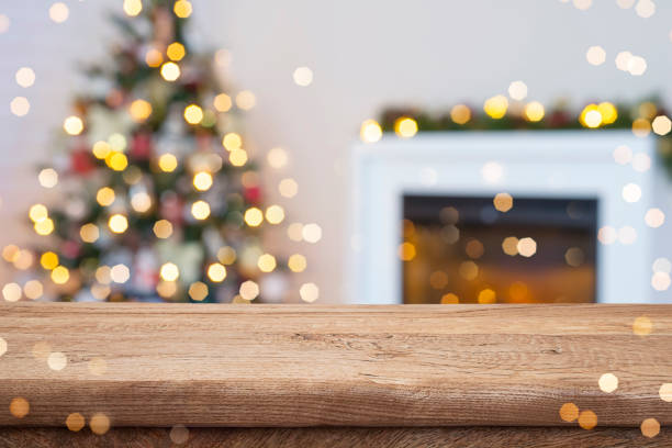 istock Holiday table background on blurred interior of Christmas tree decoration and fireplace 2176614334