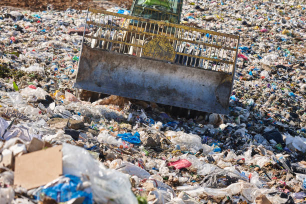 istock Heavy machinery shredding garbage in an open air landfill. Pollution 2176615292