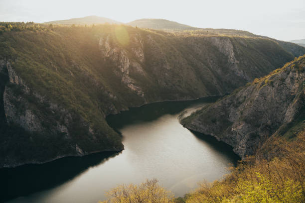 istock Stunning sunset over a serene river valley surrounded by rugged cliffs in the mountains of early spring in Serbia 2176615555