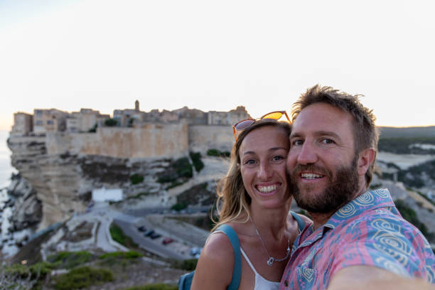 istock Happy Couple Taking a Selfie with Cliffside Town at Sunset 2176618952