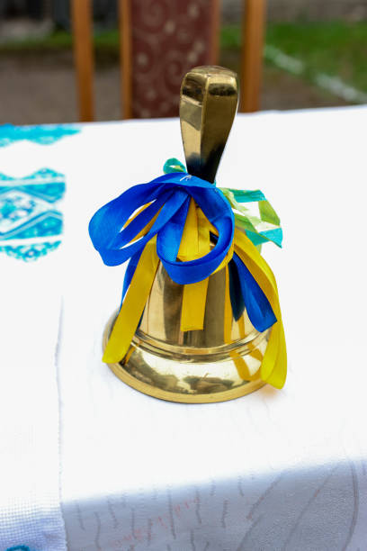 A golden bell with a yellow-blue ribbon.
