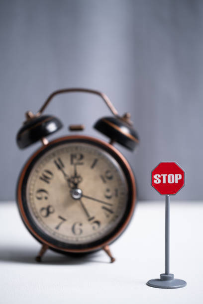 istock Stop sign with alarm clock in the background. Time management concept. 2176619639