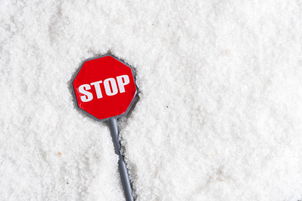 Stop sign on pile of white salt. Conceptual image stop salt